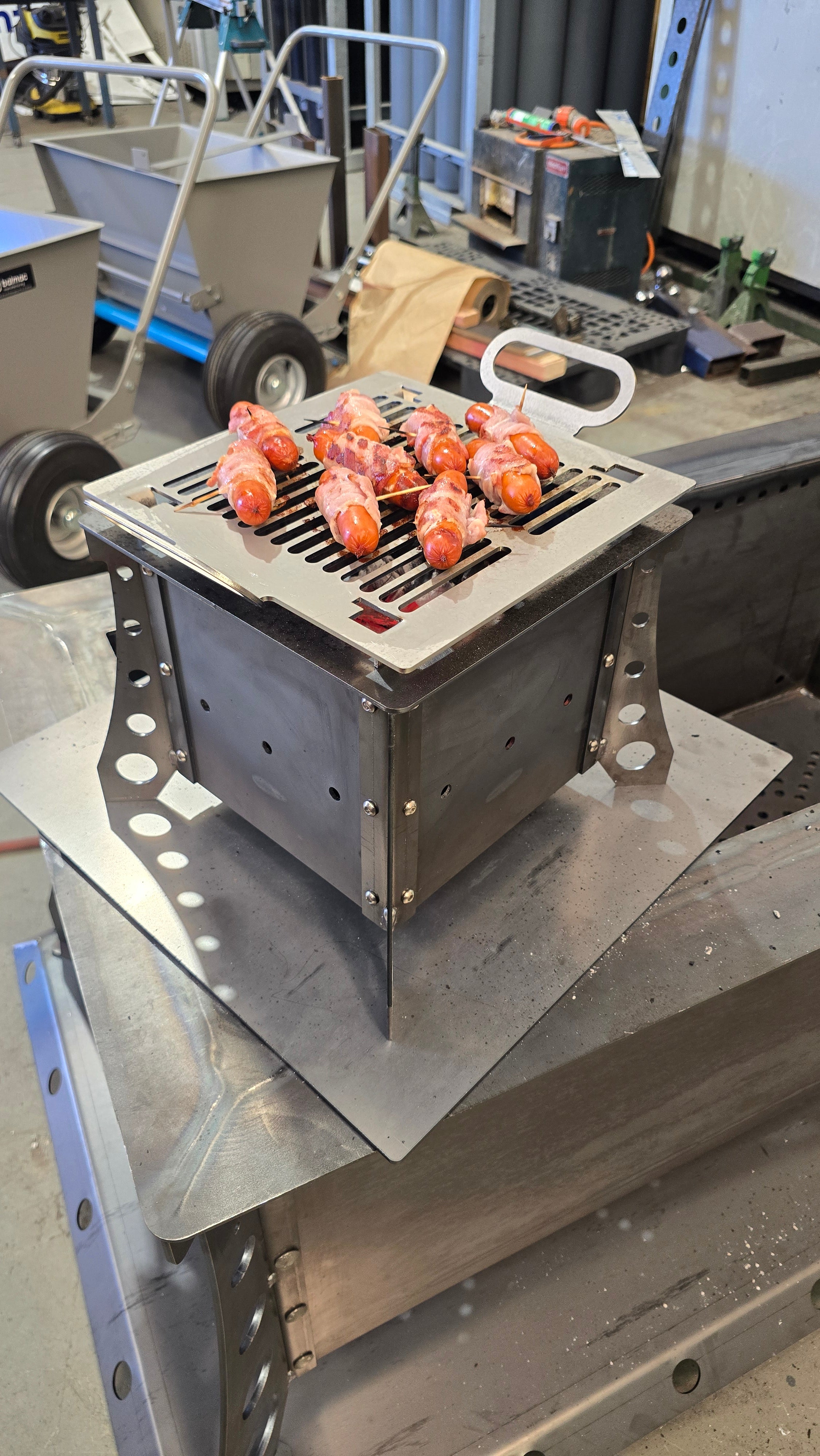 Food cooking on the Hades Small Hibachi Grill in the workshop