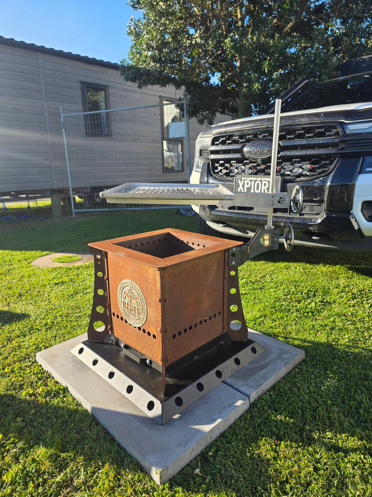 Hades 36 Litre Fire Box with a weathered Corten finish at the Bay Home Show in Tauranga. Optional grill and base shown are priced separately.
