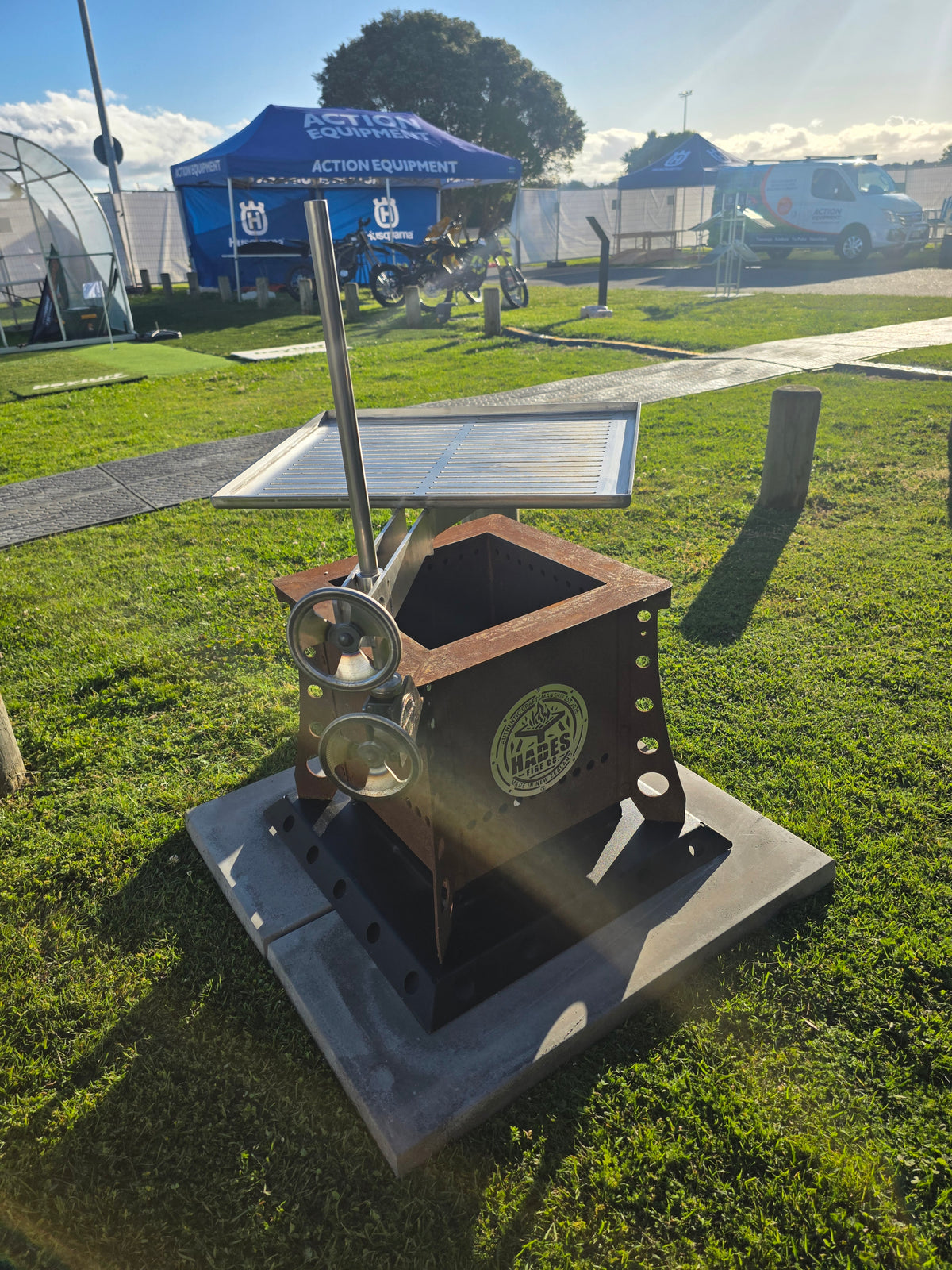 Hades 36 Litre Fire Box in a dark steel finish at the Bay Home Show in Tauranga. Optional grill and base shown are priced separately.